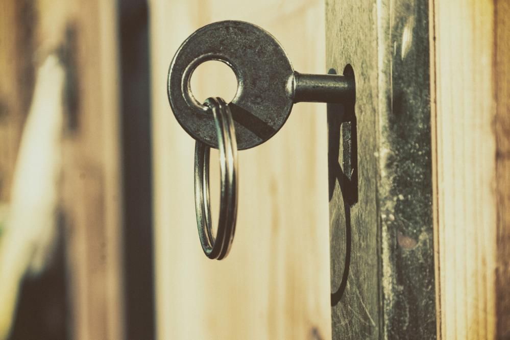 A man is fixing a door with a key.