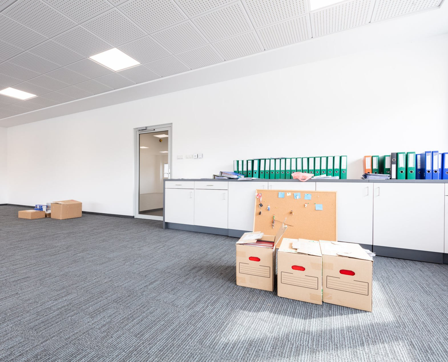 an empty office with moving cardboard boxes