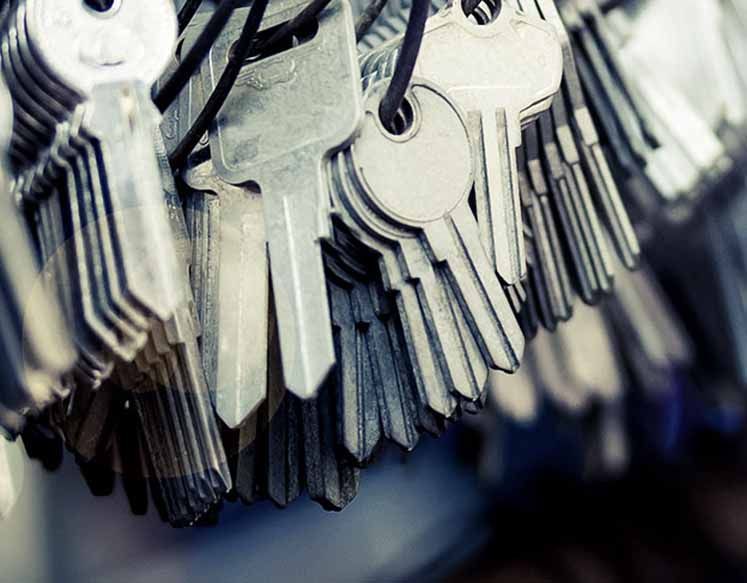 A bunch of keys hanging from a string.