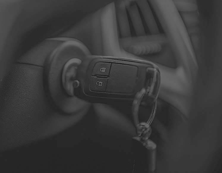 A close up of a car key in the ignition of a car.