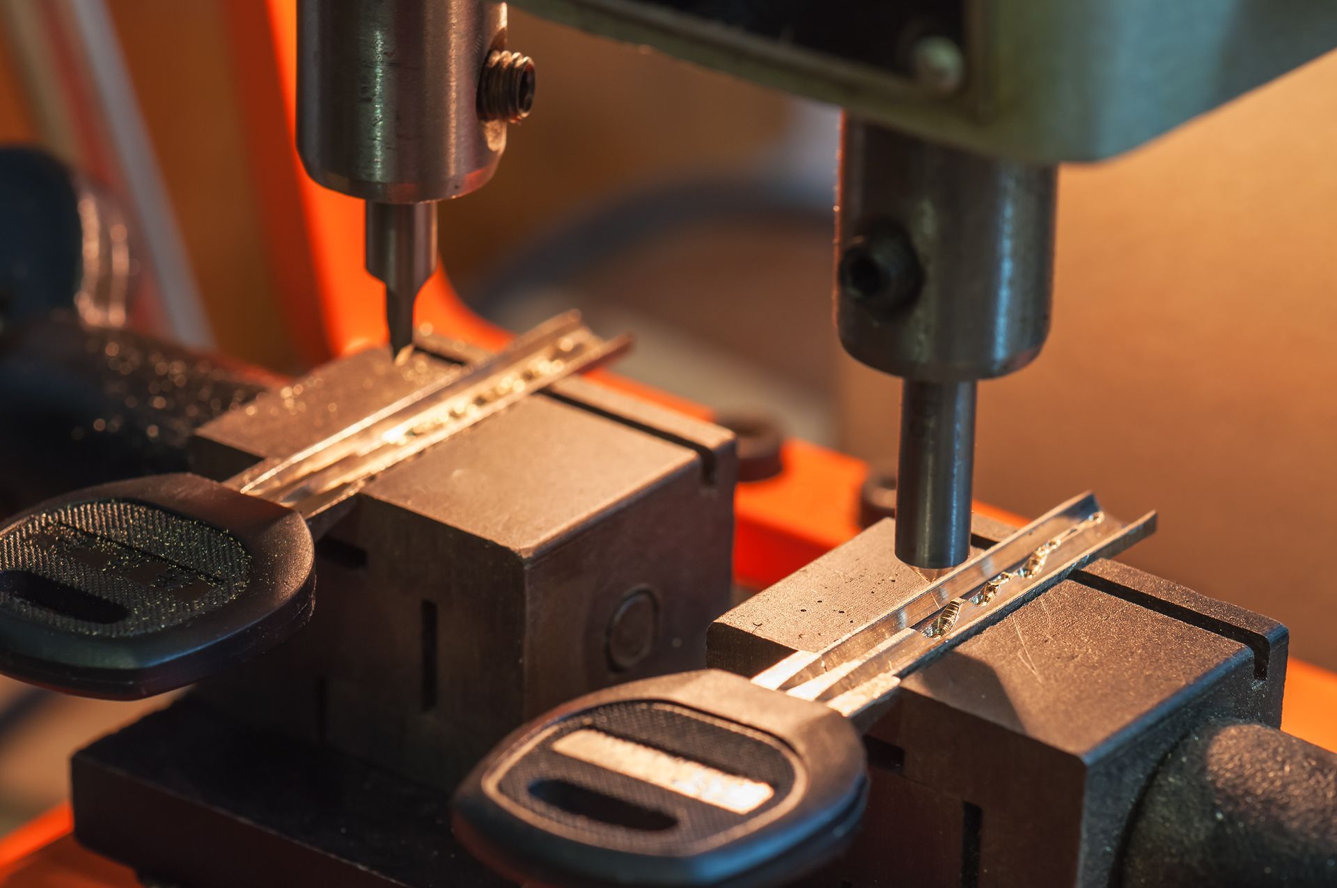 A close up of a key being cut on a machine.