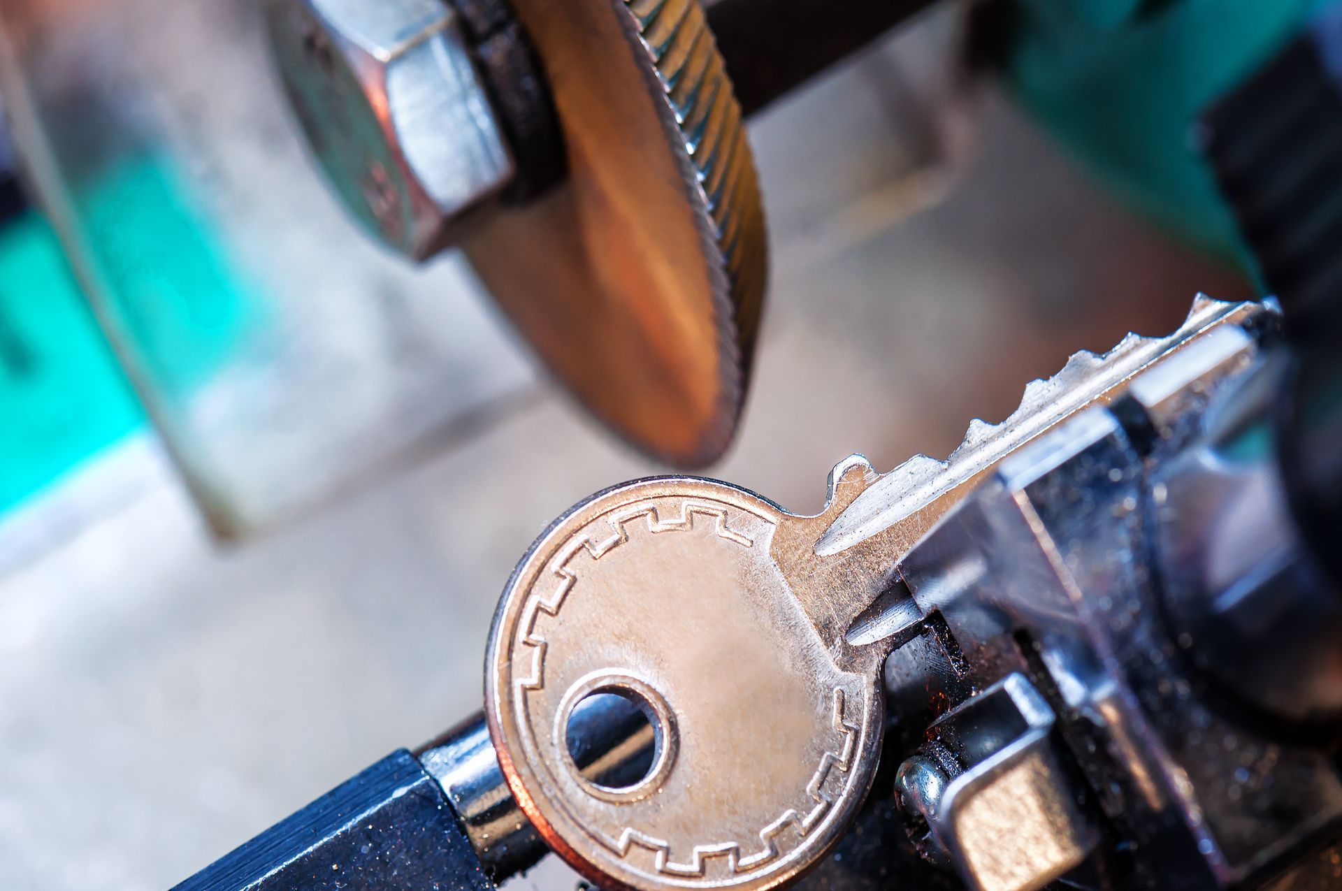 A close up of a key being cut by a machine.