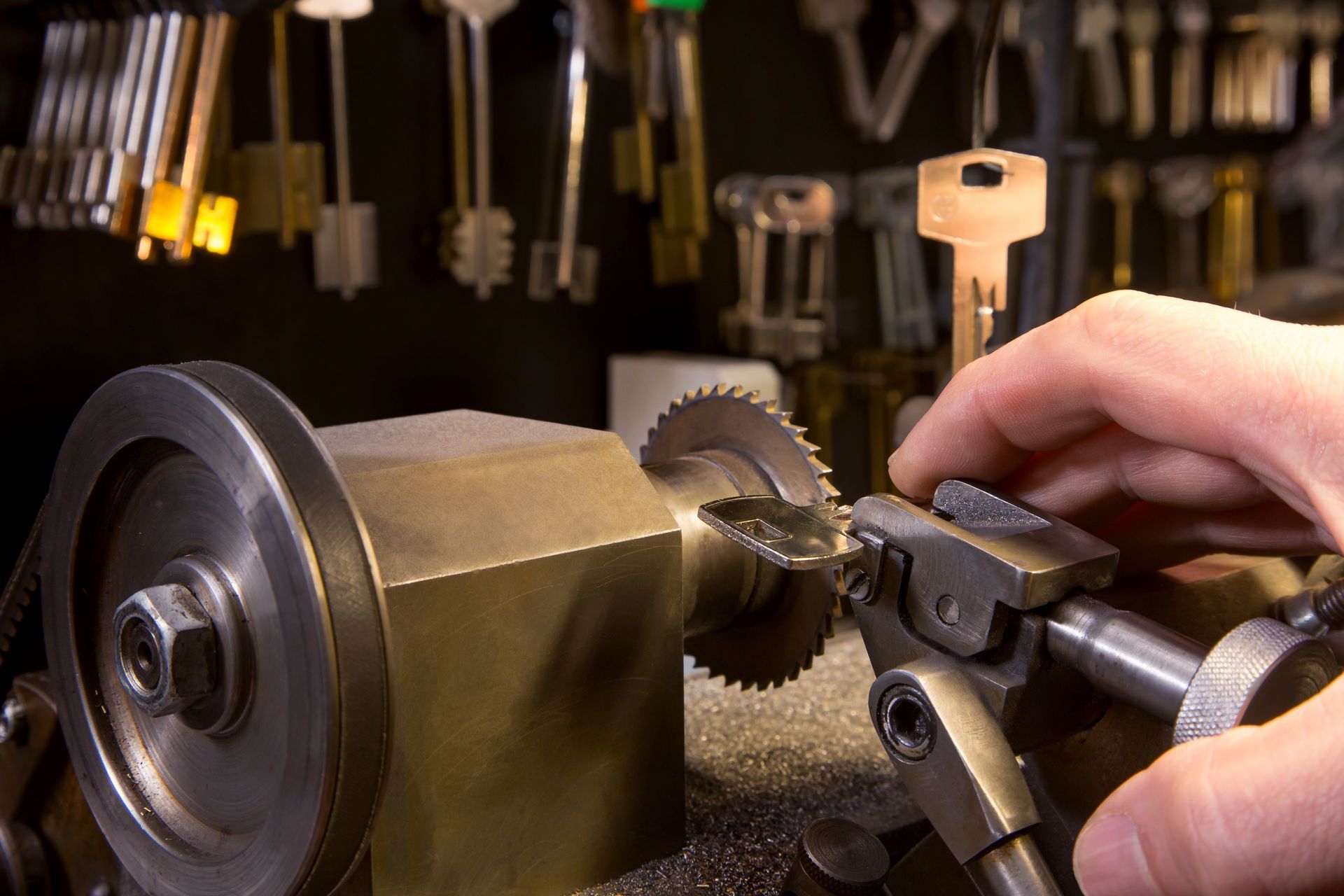 A person is cutting a key with a machine.