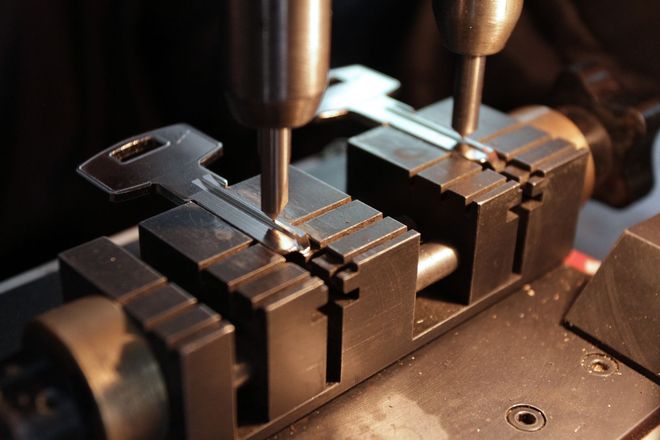 A machine is cutting a key into a piece of metal.