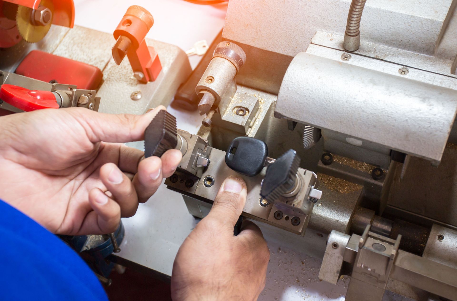 A man is cutting a key with a machine.