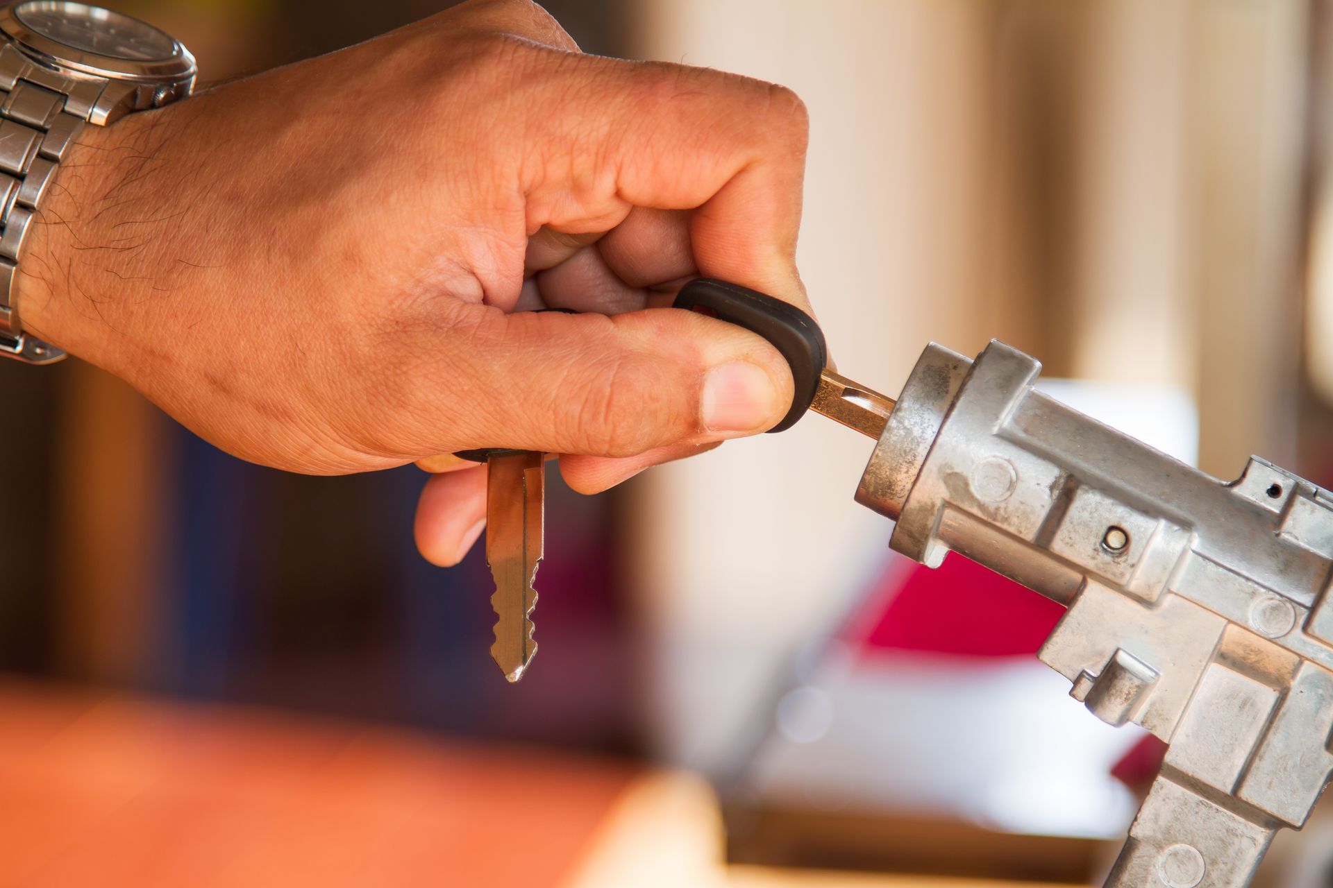 A close up of a person holding a car key in their hand.