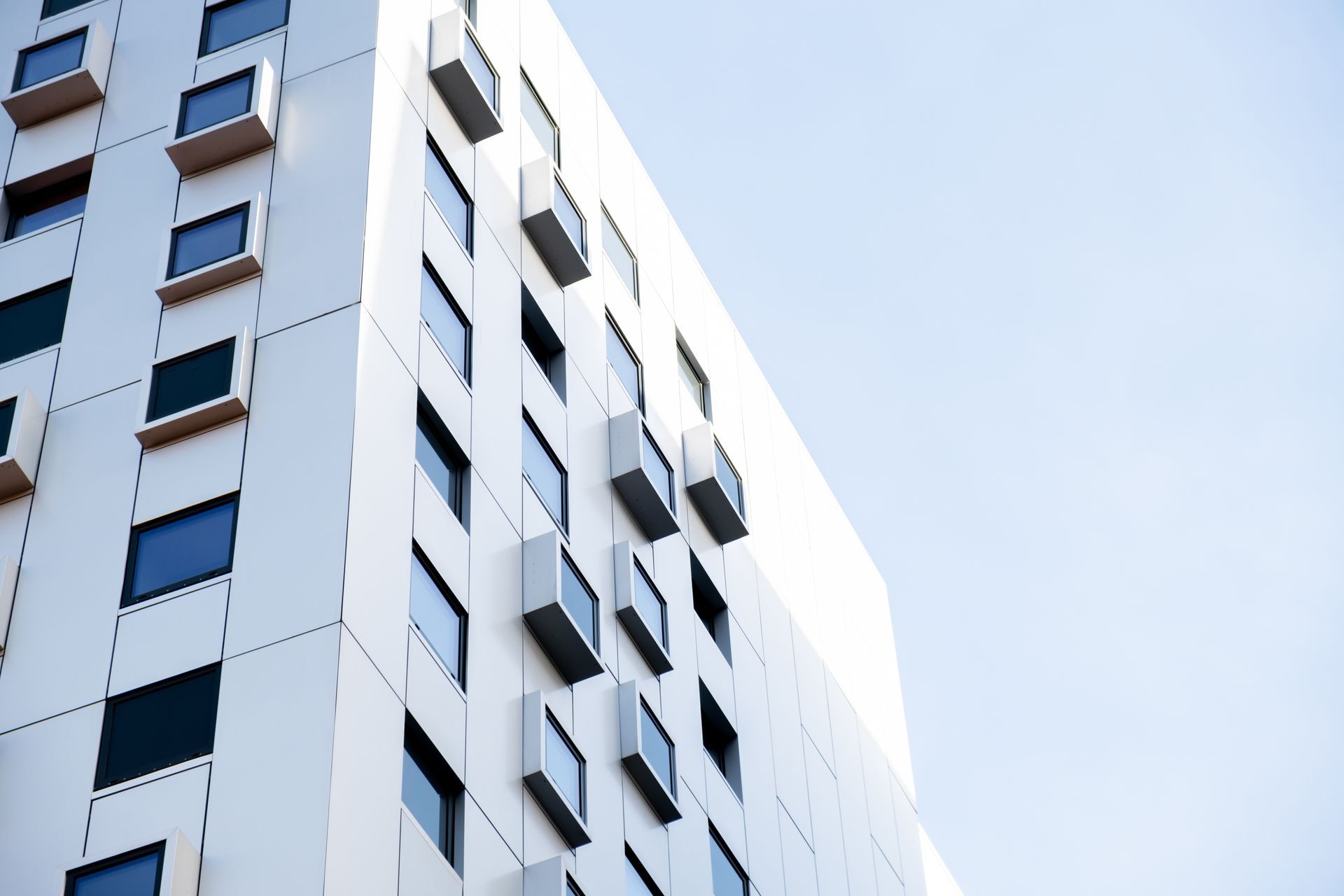 Looking up at a tall building with lots of windows