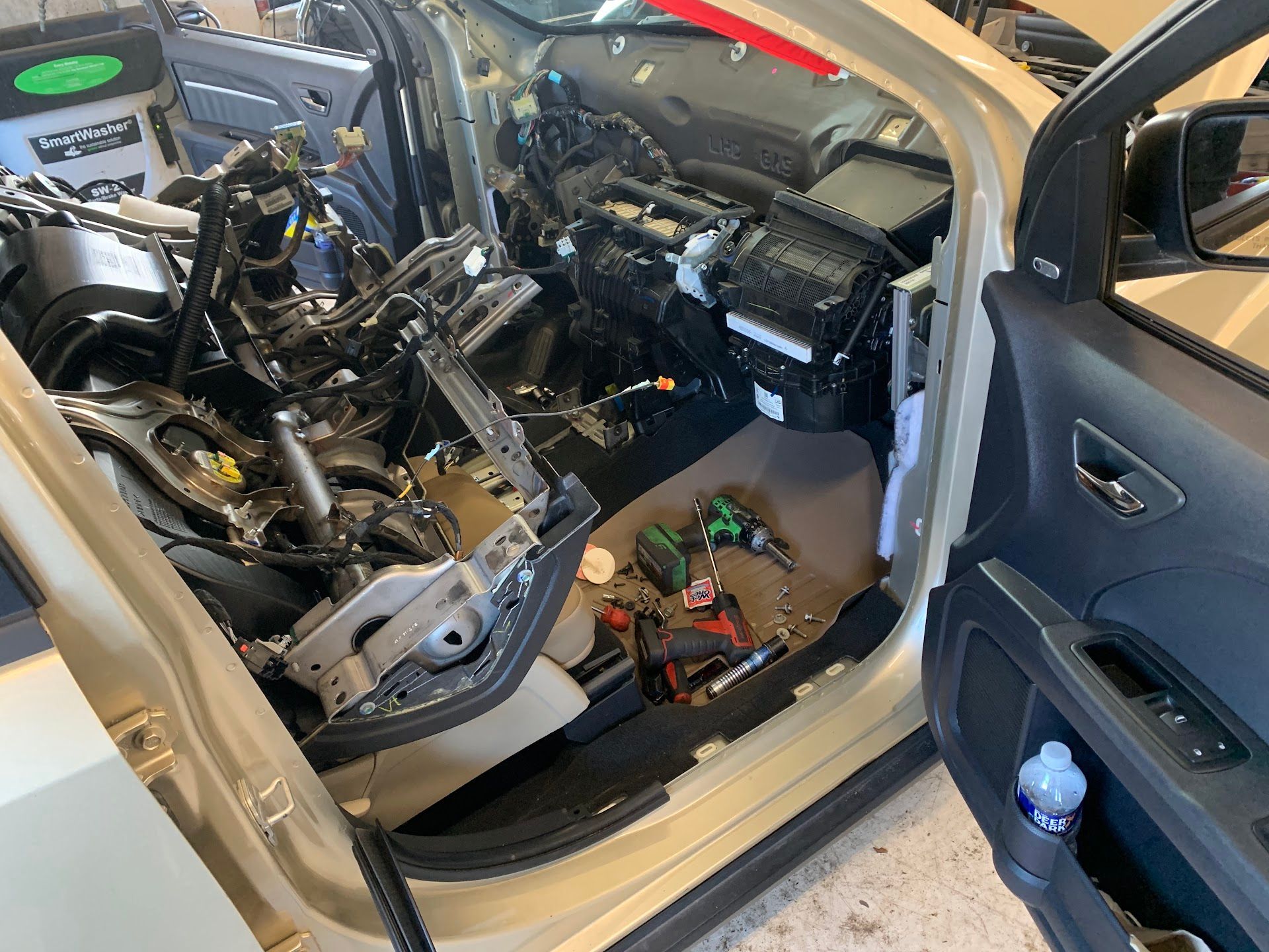 Car's interior disassembled for repair, revealing components and tools | JP Automotive, LLC