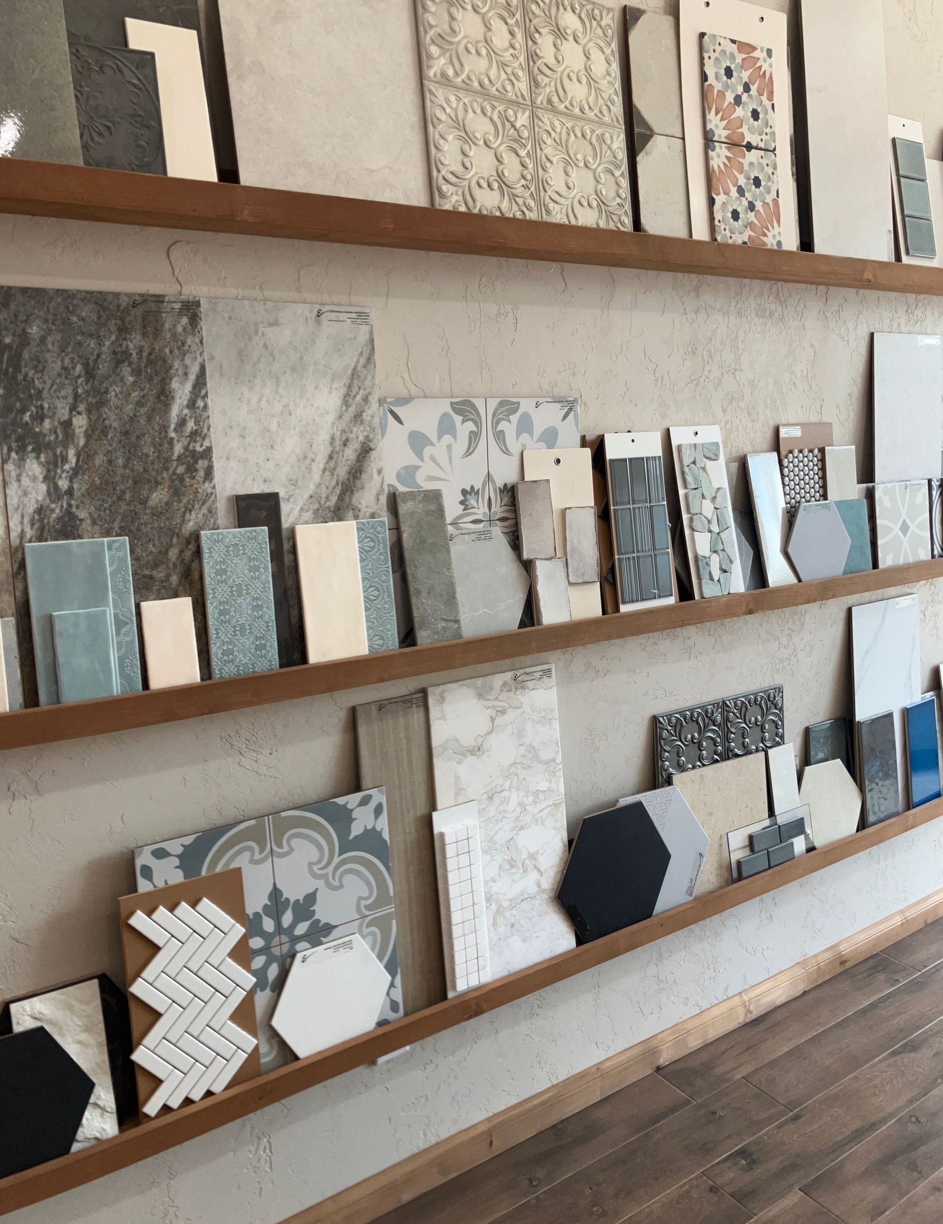 Shelves displaying various tile samples in different colors and patterns, for design inspiration.