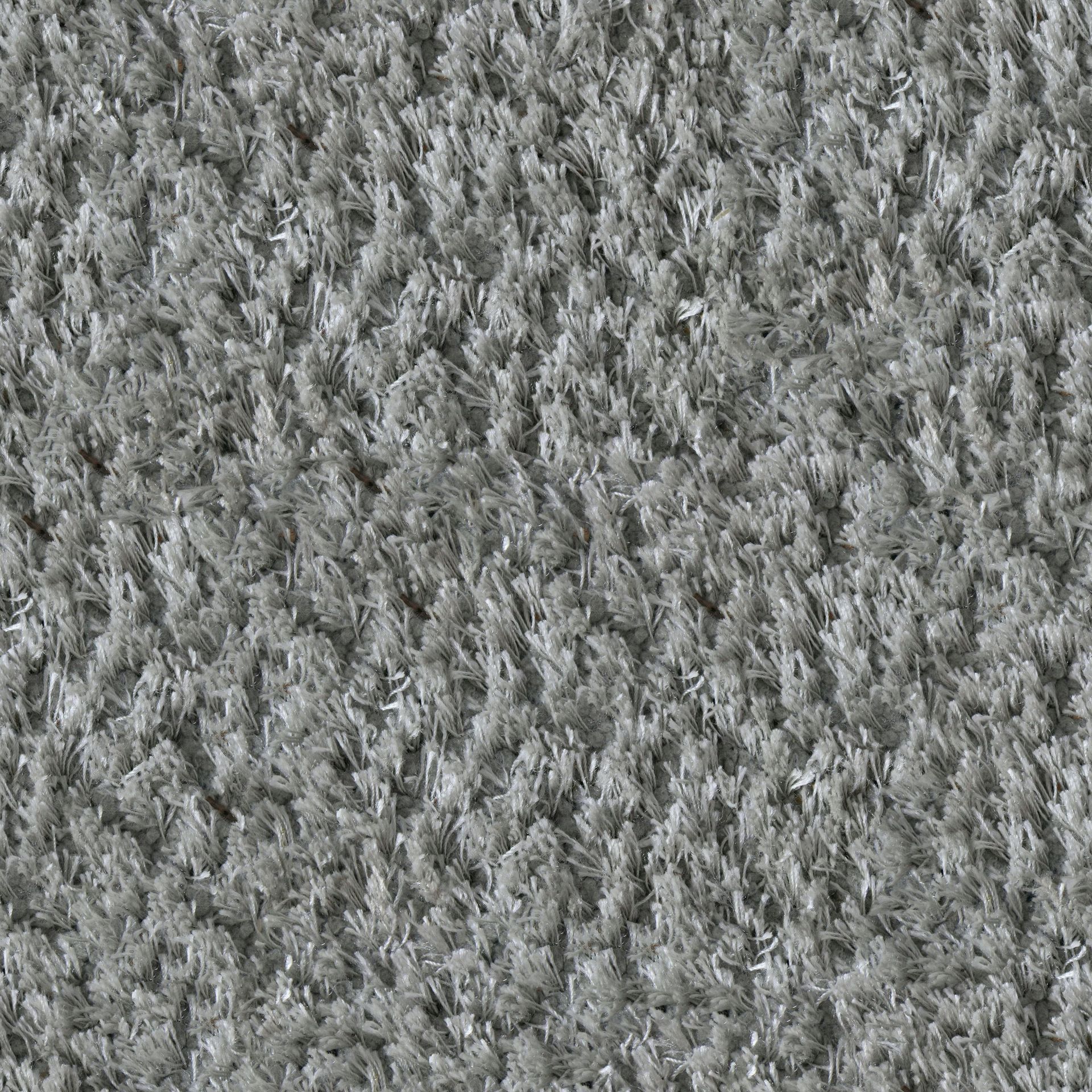 Close-up of a grey carpet with a shaggy, textured appearance.