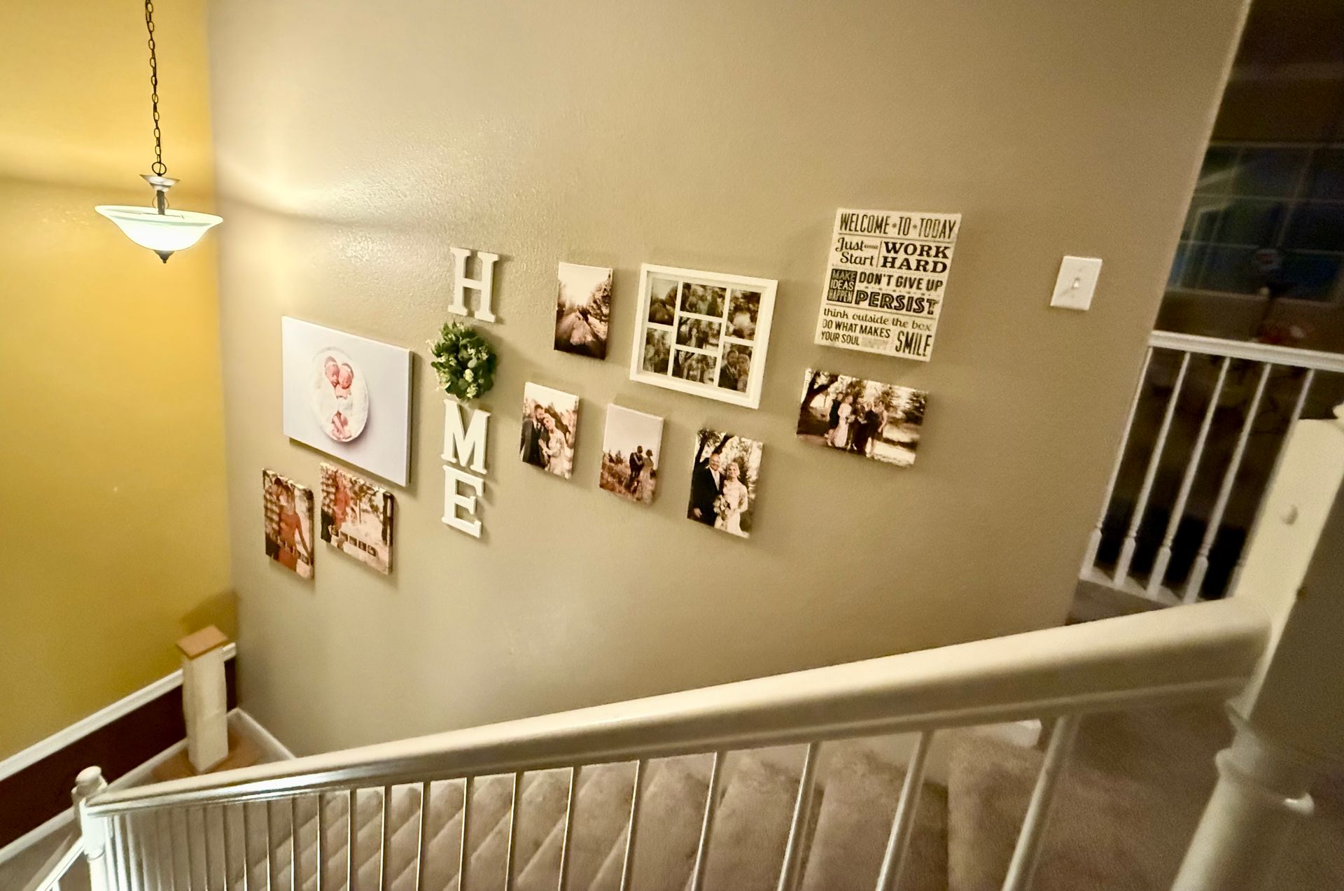 A staircase wall decorated with photos and 