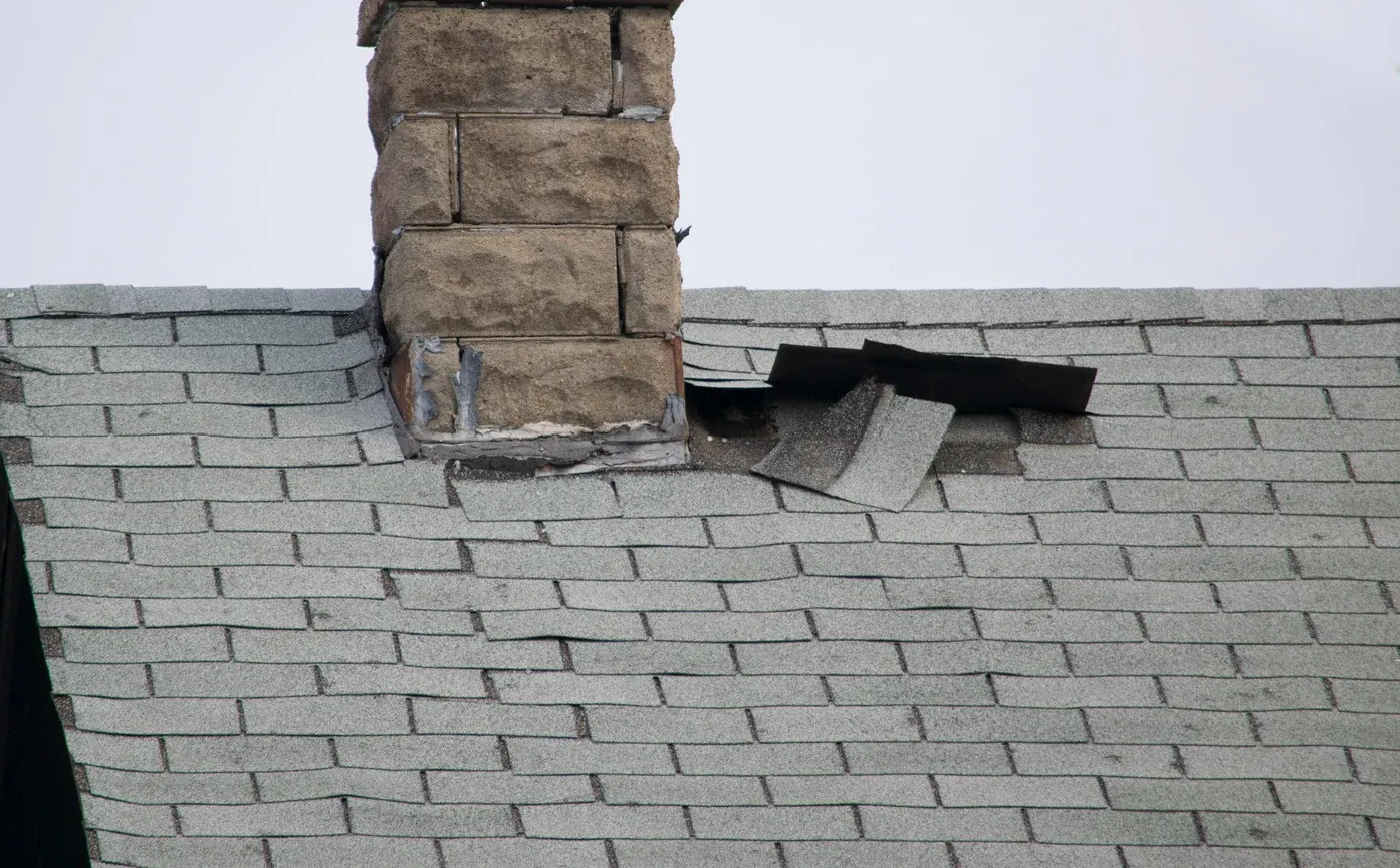 Bathroom with rustic wood vanity, black bowl sink, tiled shower, and toilet.