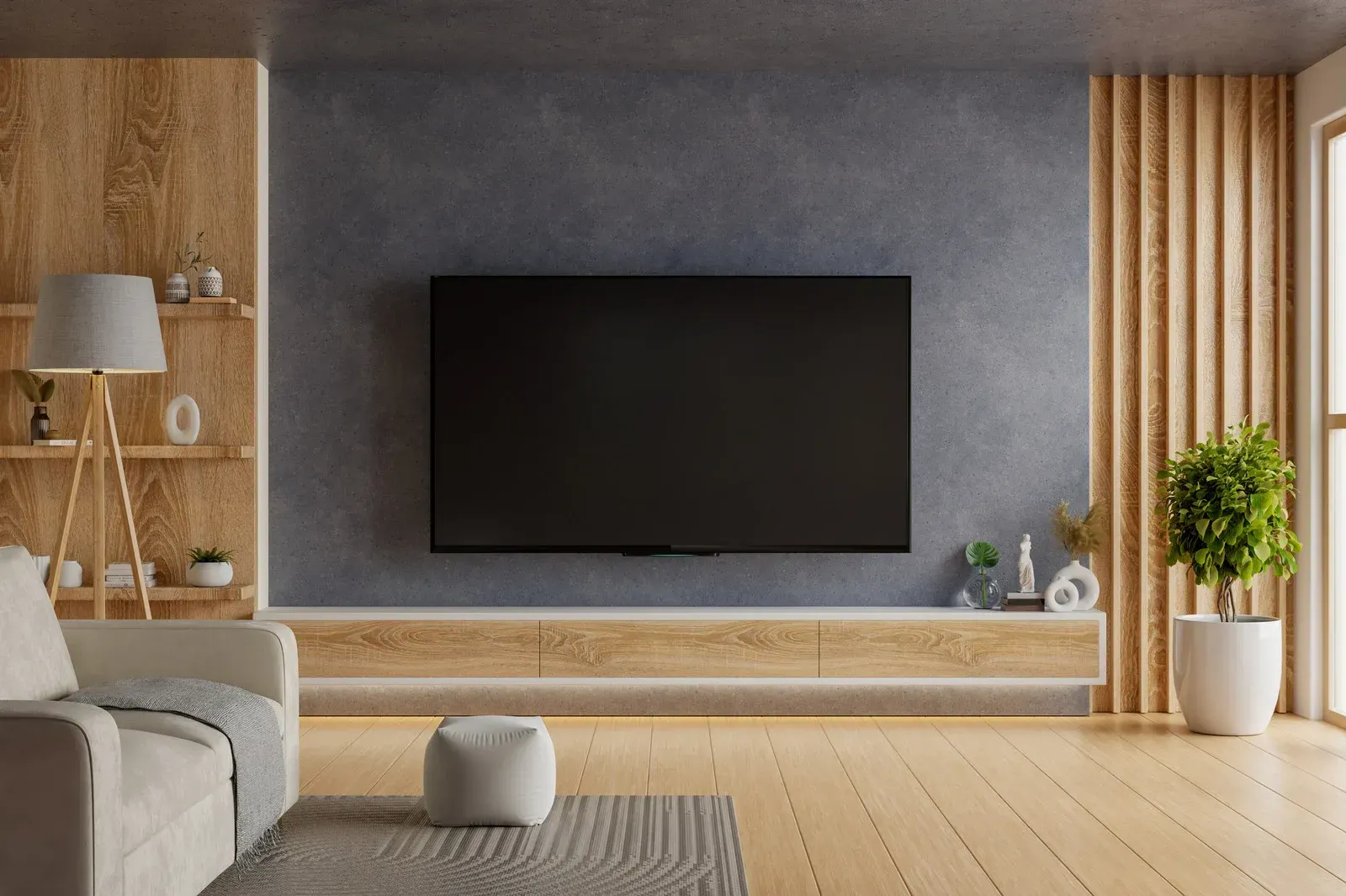 Small bathroom with a white tub, toilet, and a speckled gray and black tiled shower area.