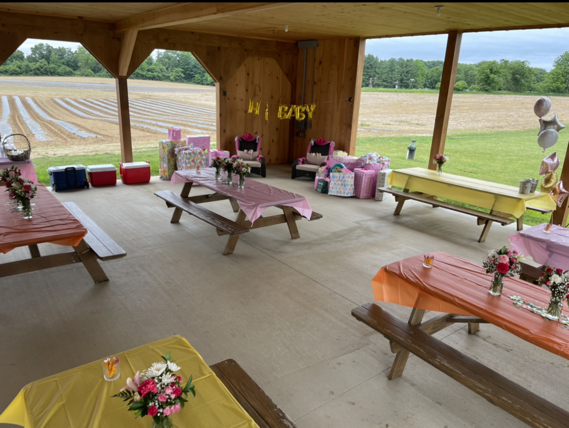 A pavilion with tables and benches and a sign that says spicy