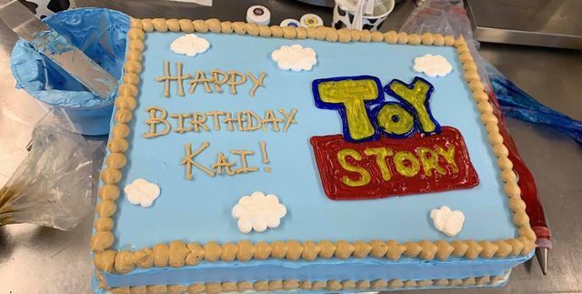 A toy story birthday cake is sitting on a table.