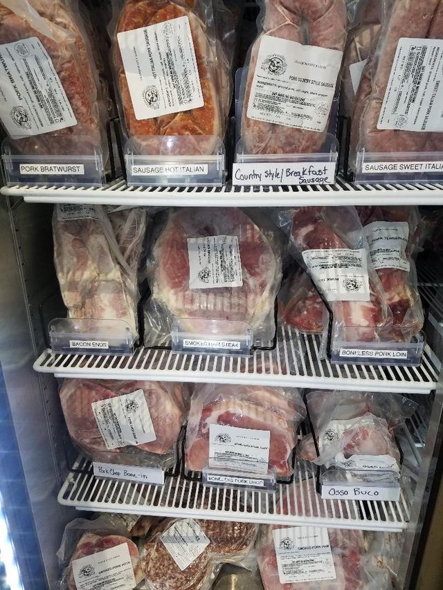A refrigerator filled with lots of different types of meat.