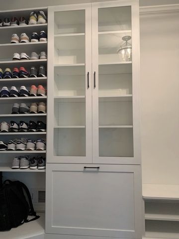 A closet filled with lots of shoes and a backpack.