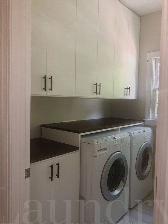 A laundry room with a washer and dryer in it