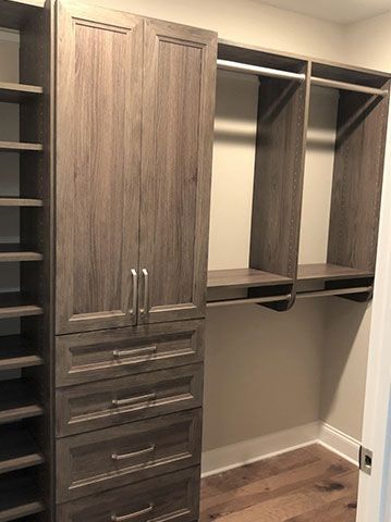 A walk in closet with lots of drawers and shelves.