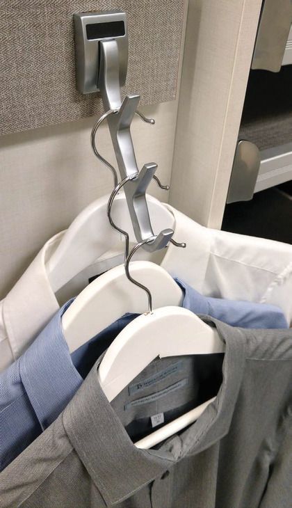 A bunch of shirts are hanging on a hook
