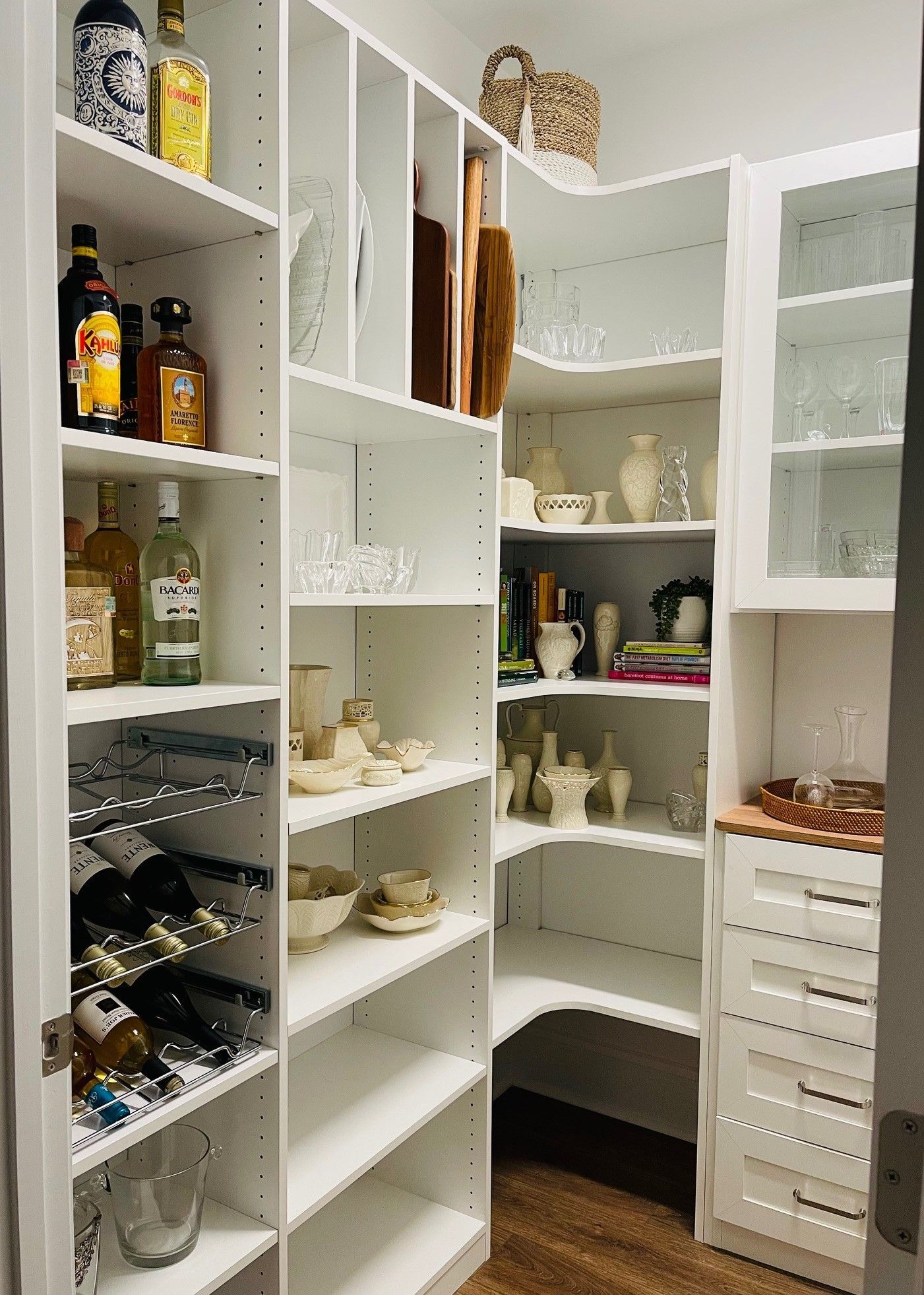 A pantry with lots of shelves and bottles on them.
