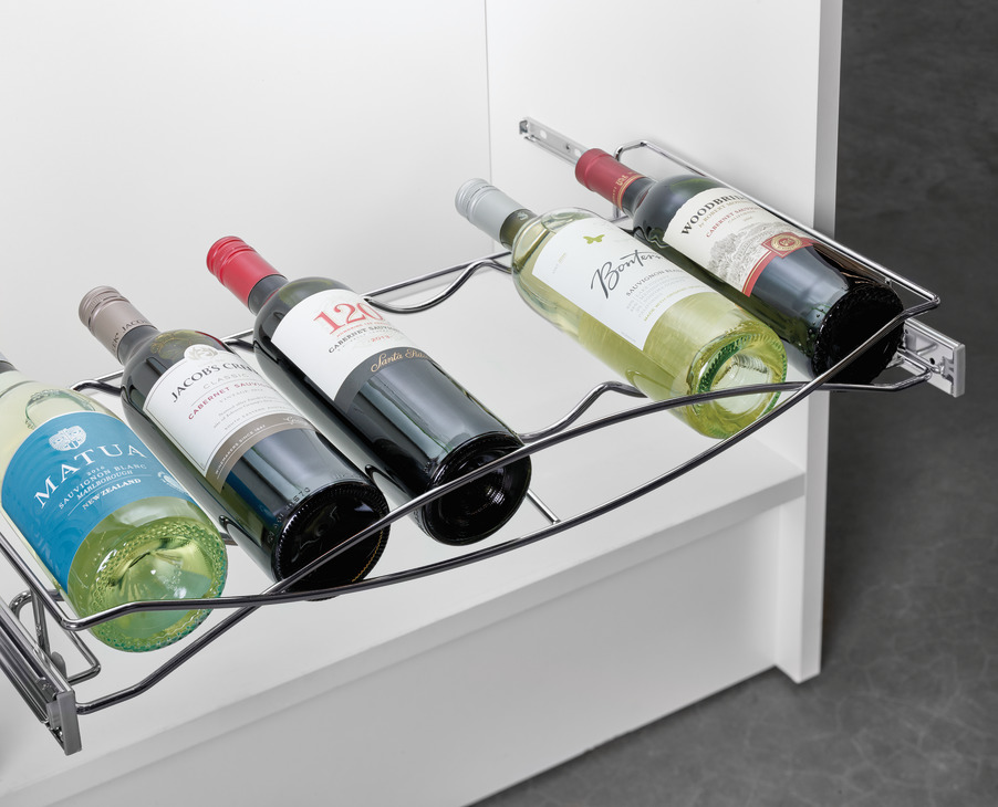 Four bottles of wine are lined up in a wine rack