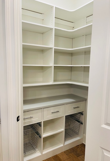 A pantry with lots of shelves and drawers
