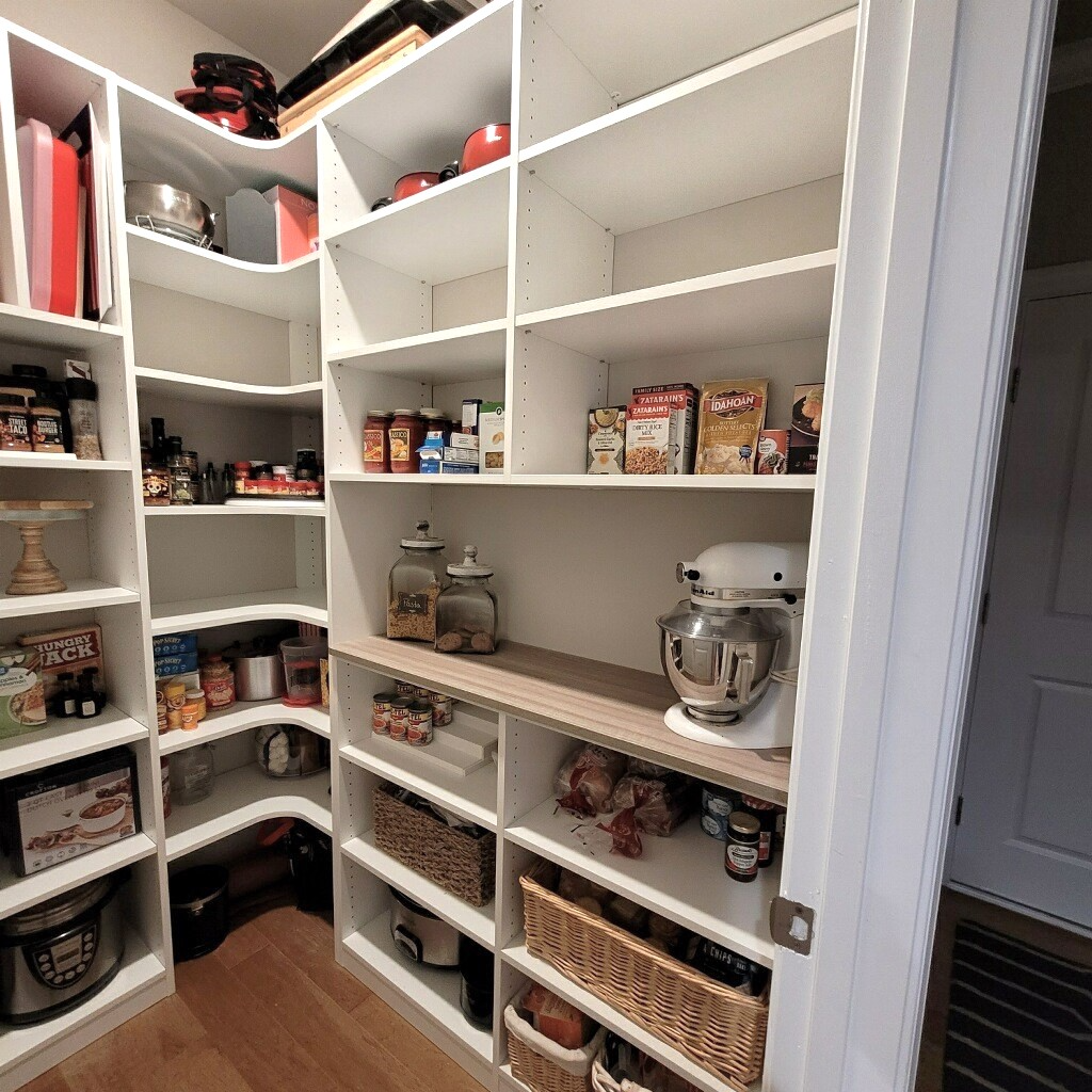 A pantry with lots of shelves filled with food and appliances.