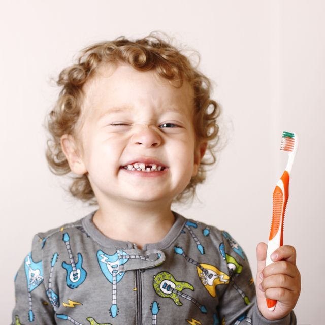 Toddler Smiling While Holding A Toothbrush - Shellharbour, NSW - Shellharbour City Dental