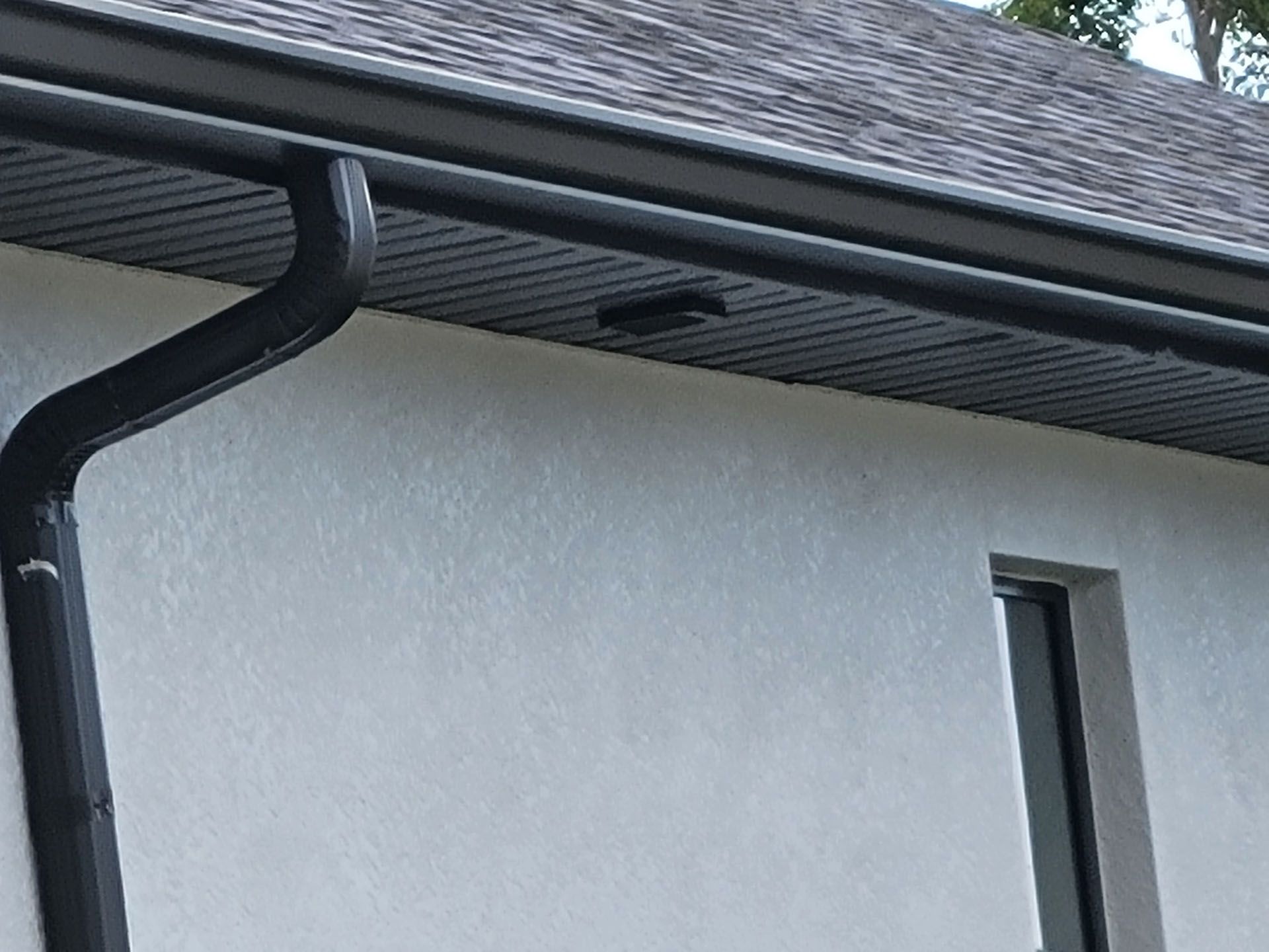 Close up shot of a black gutter — St. Cloud, FL — MJ’s Home Solutions LLC