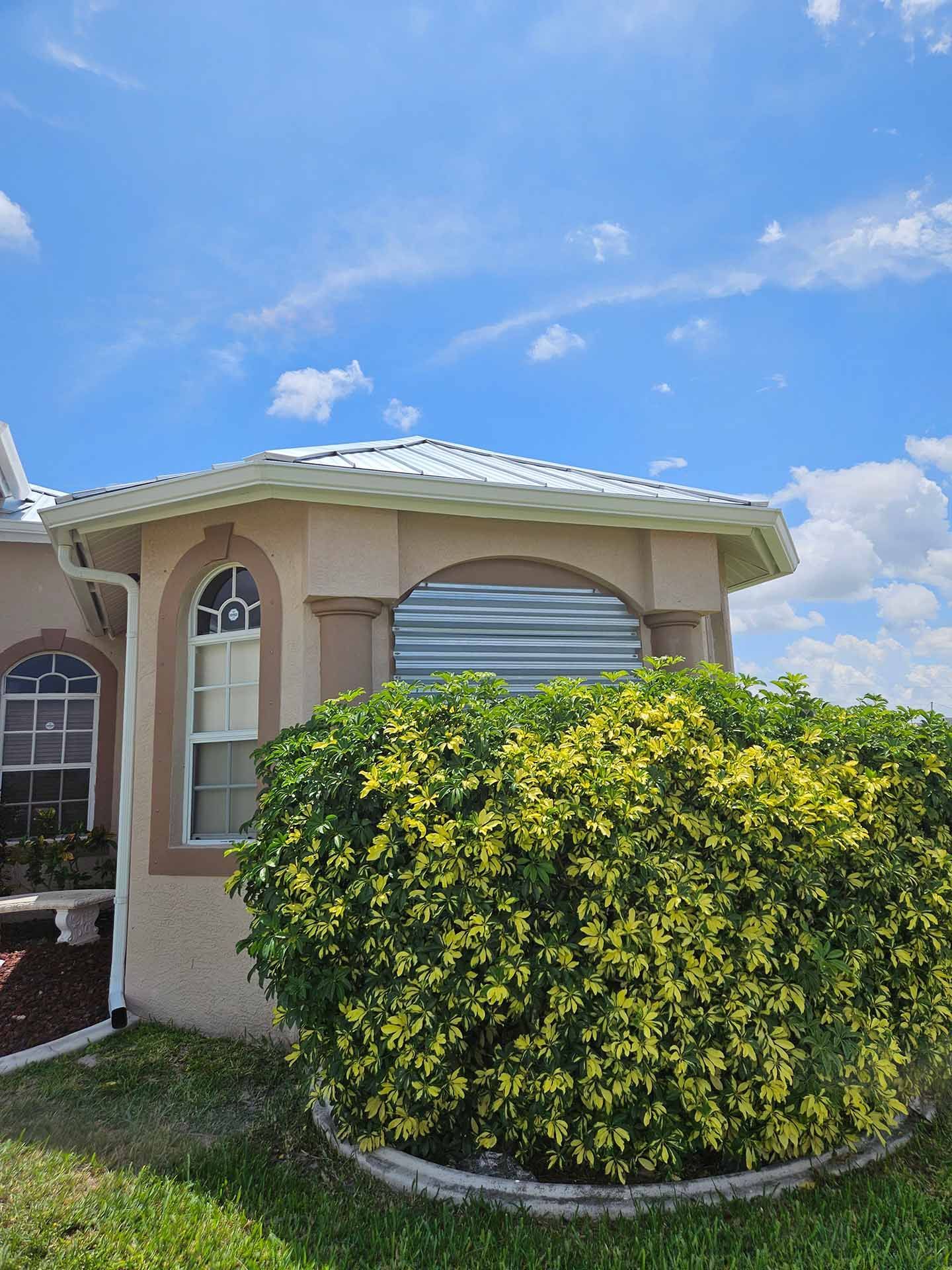 Small room with gutter and bush in front of it — St. Cloud, FL — MJ’s Home Solutions LLC