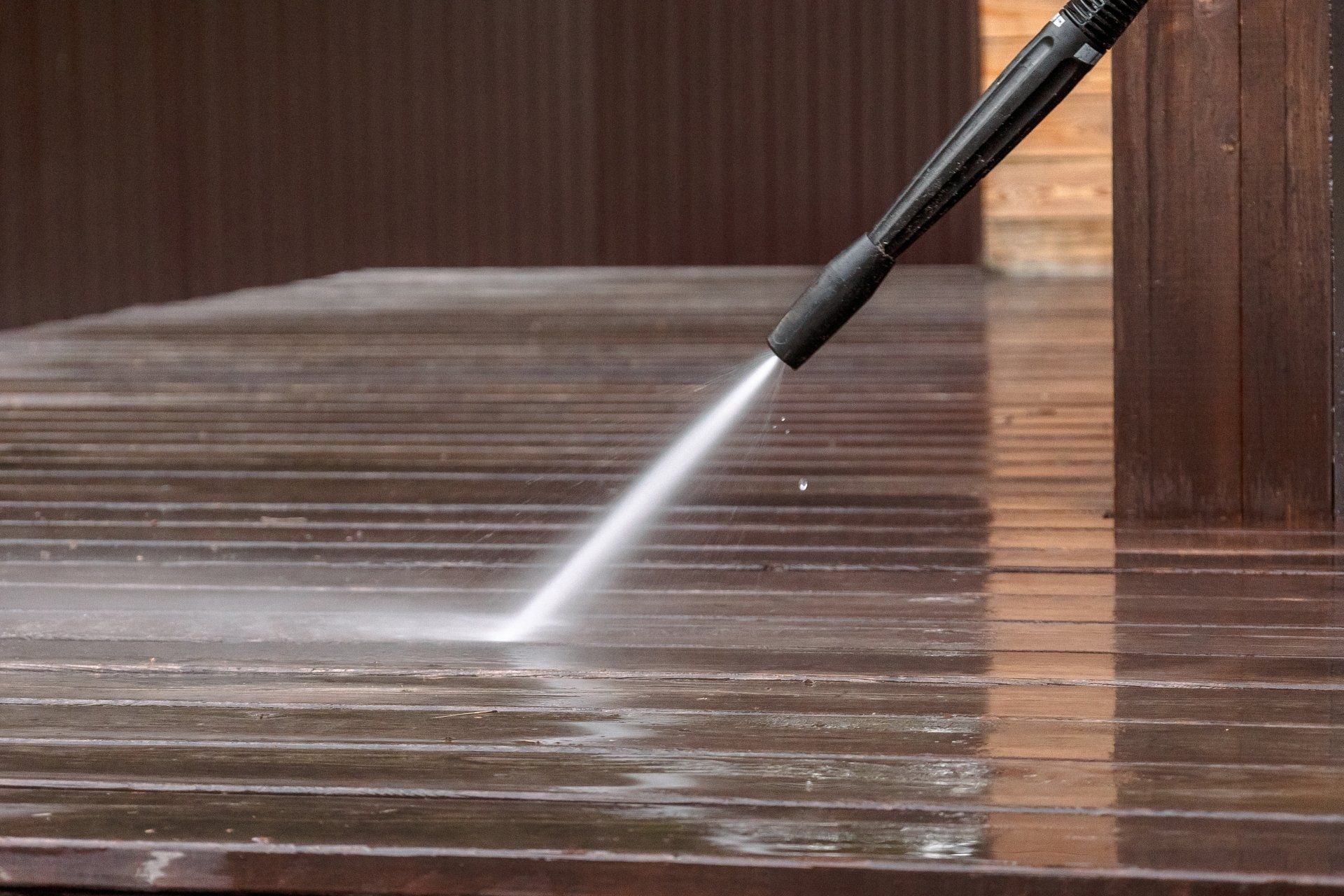man pressure washing floors