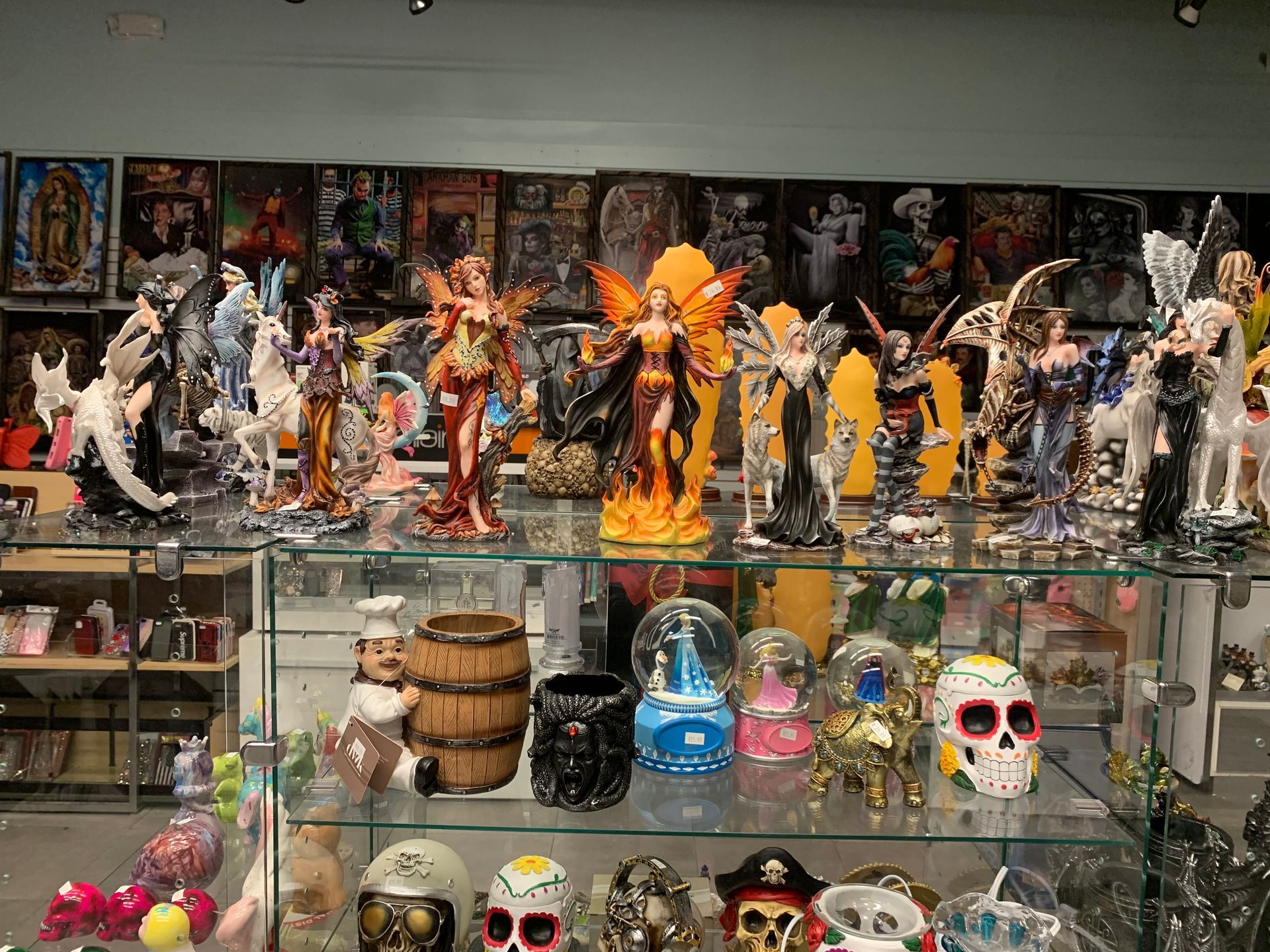 A display case filled with lots of figurines and skulls in a store.