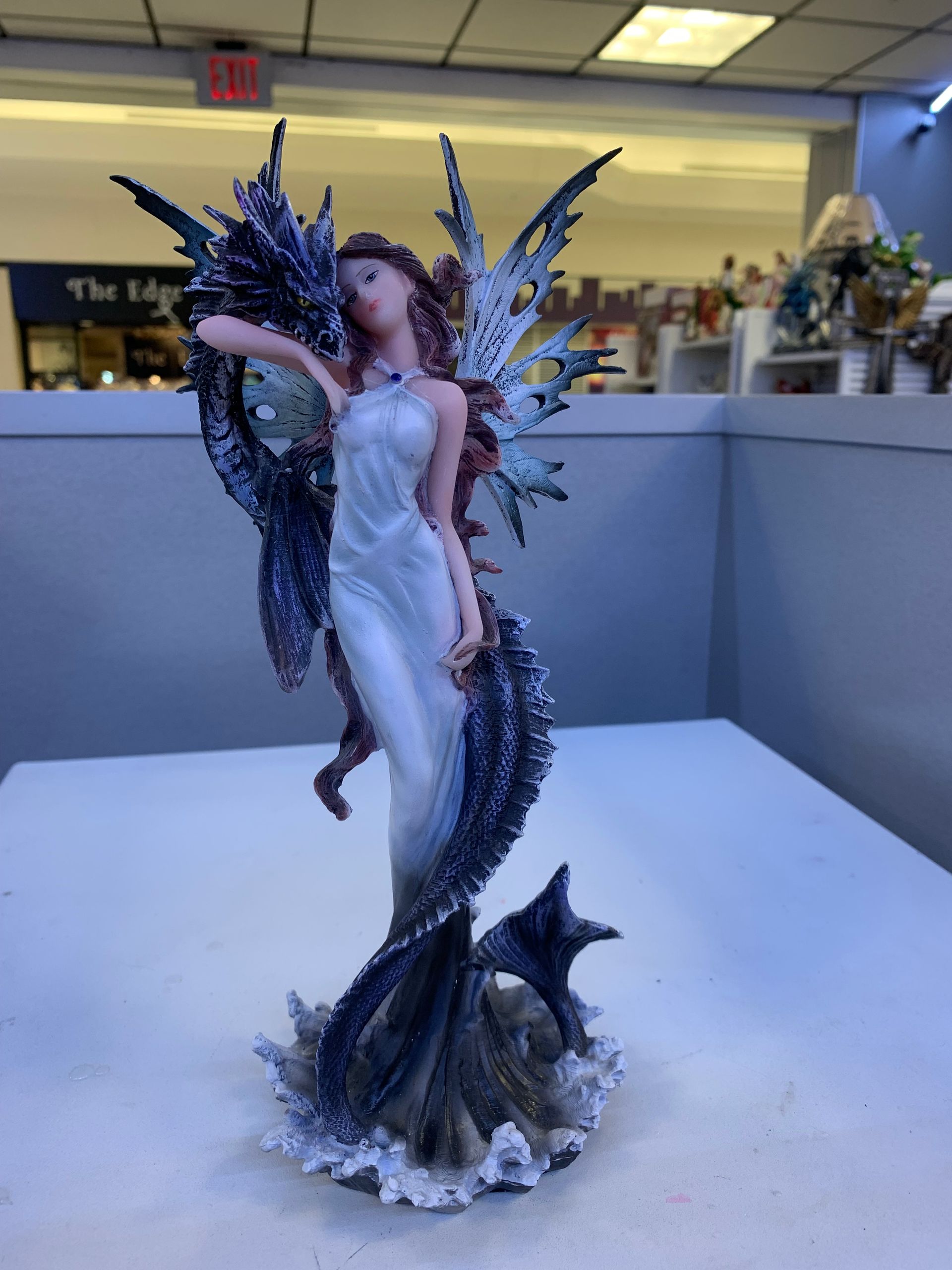 A statue of a fairy with a dragon tail