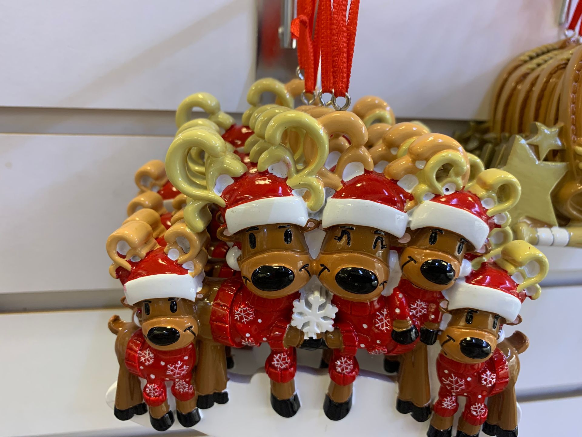 A bunch of reindeer ornaments are sitting on a table