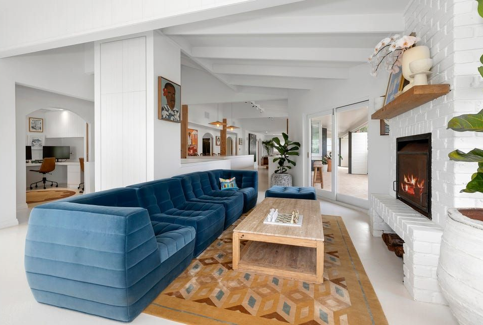 Bright Living Room With Blue Sectional Sofa, and White Fireplace — Greg Pollard Building in Banora Point, NSW