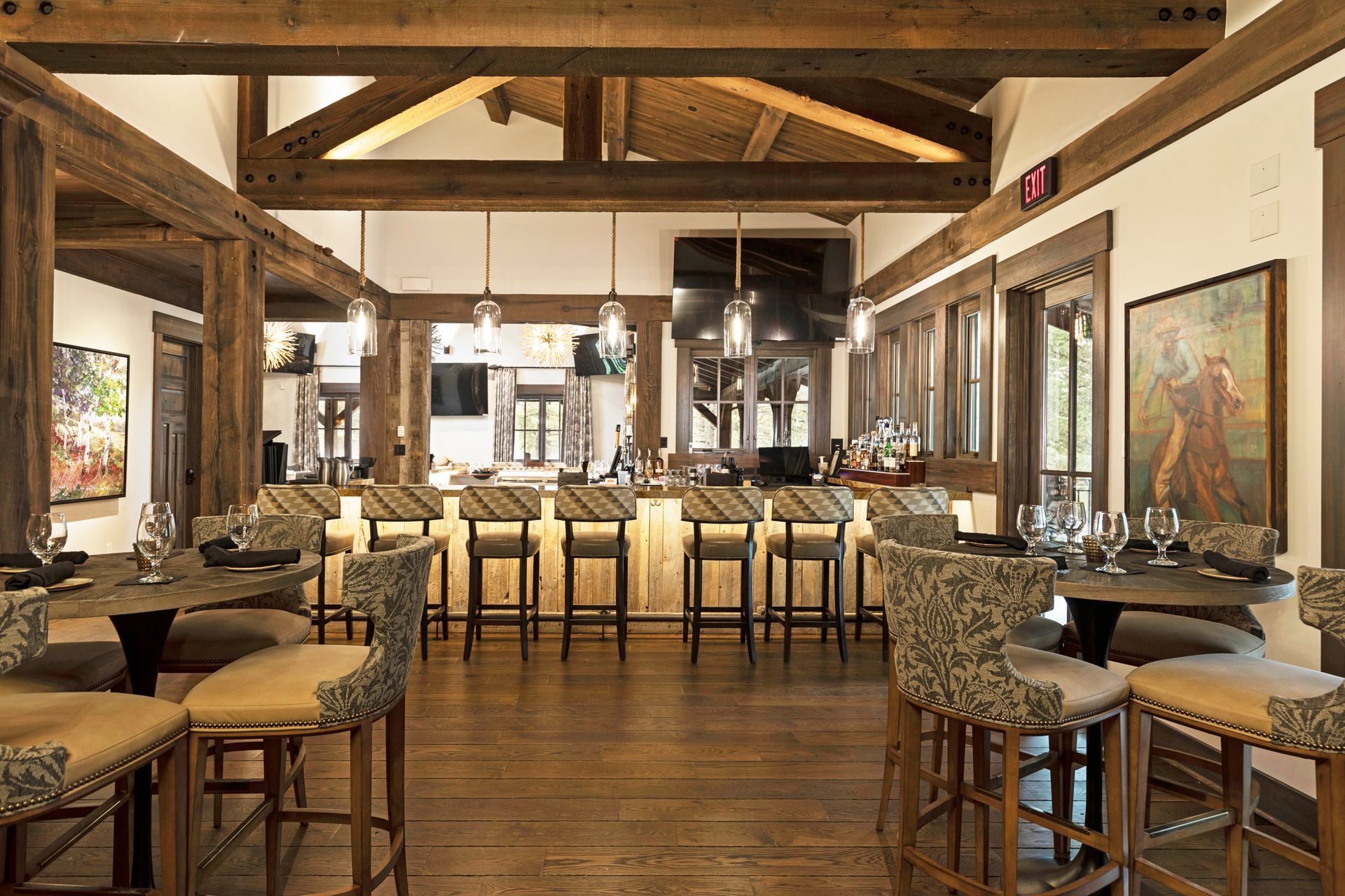 A restaurant with tables and chairs and a bar.
