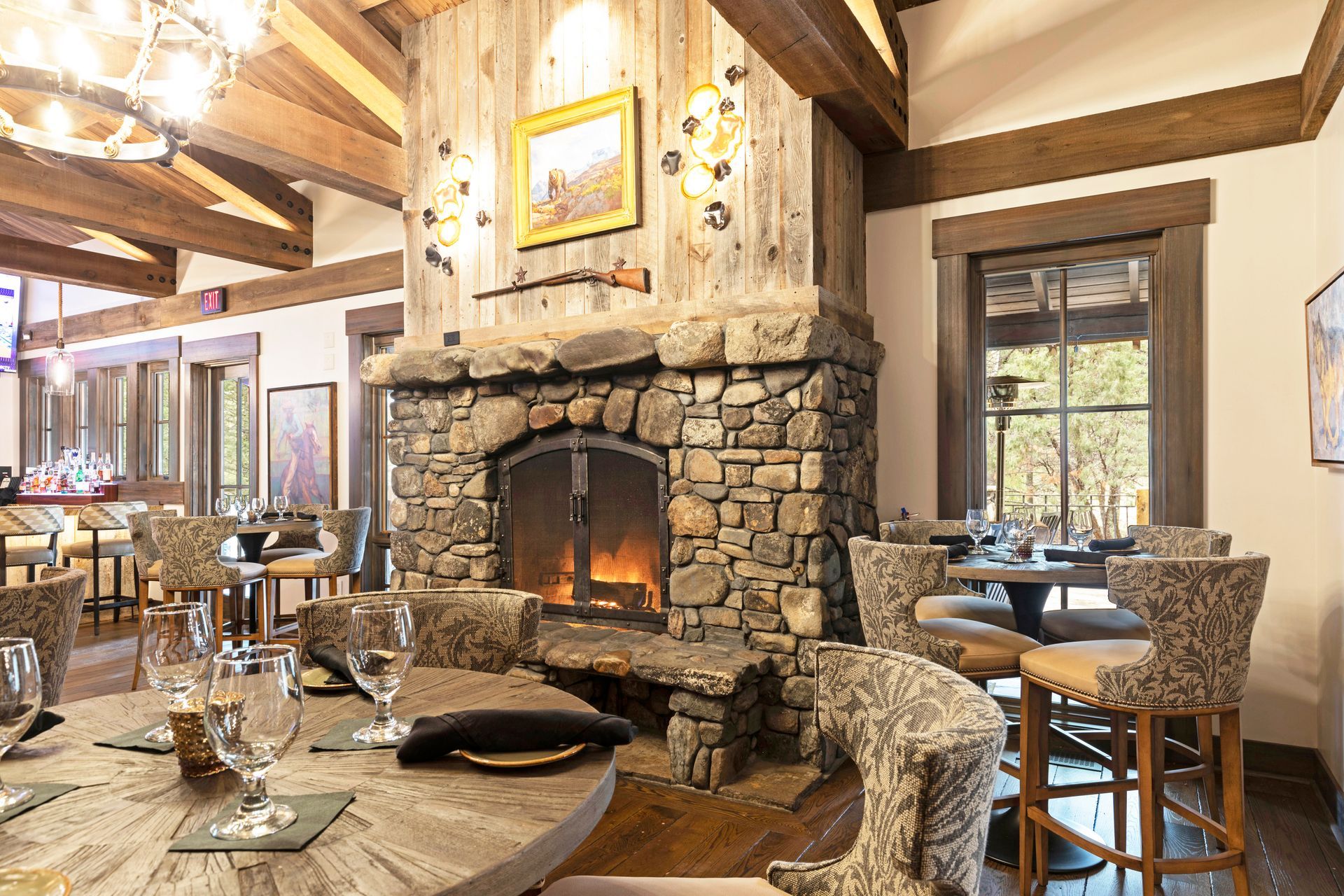 There is a stone fireplace in the middle of the room.