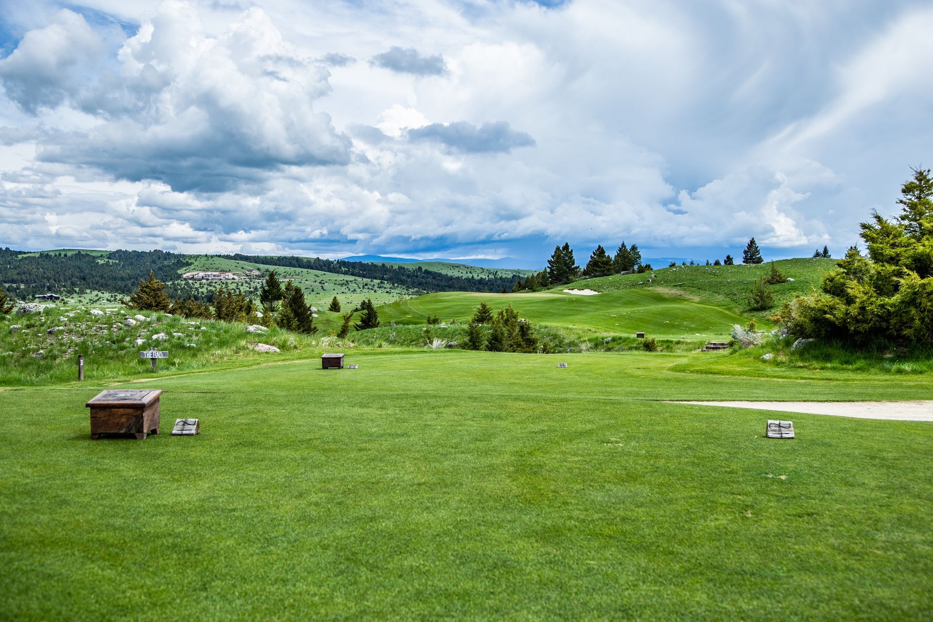 A golf course with a wooden box in the middle of it.