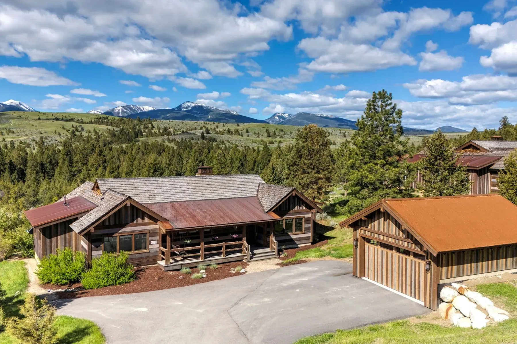 An aerial view of a house with mountains in the background