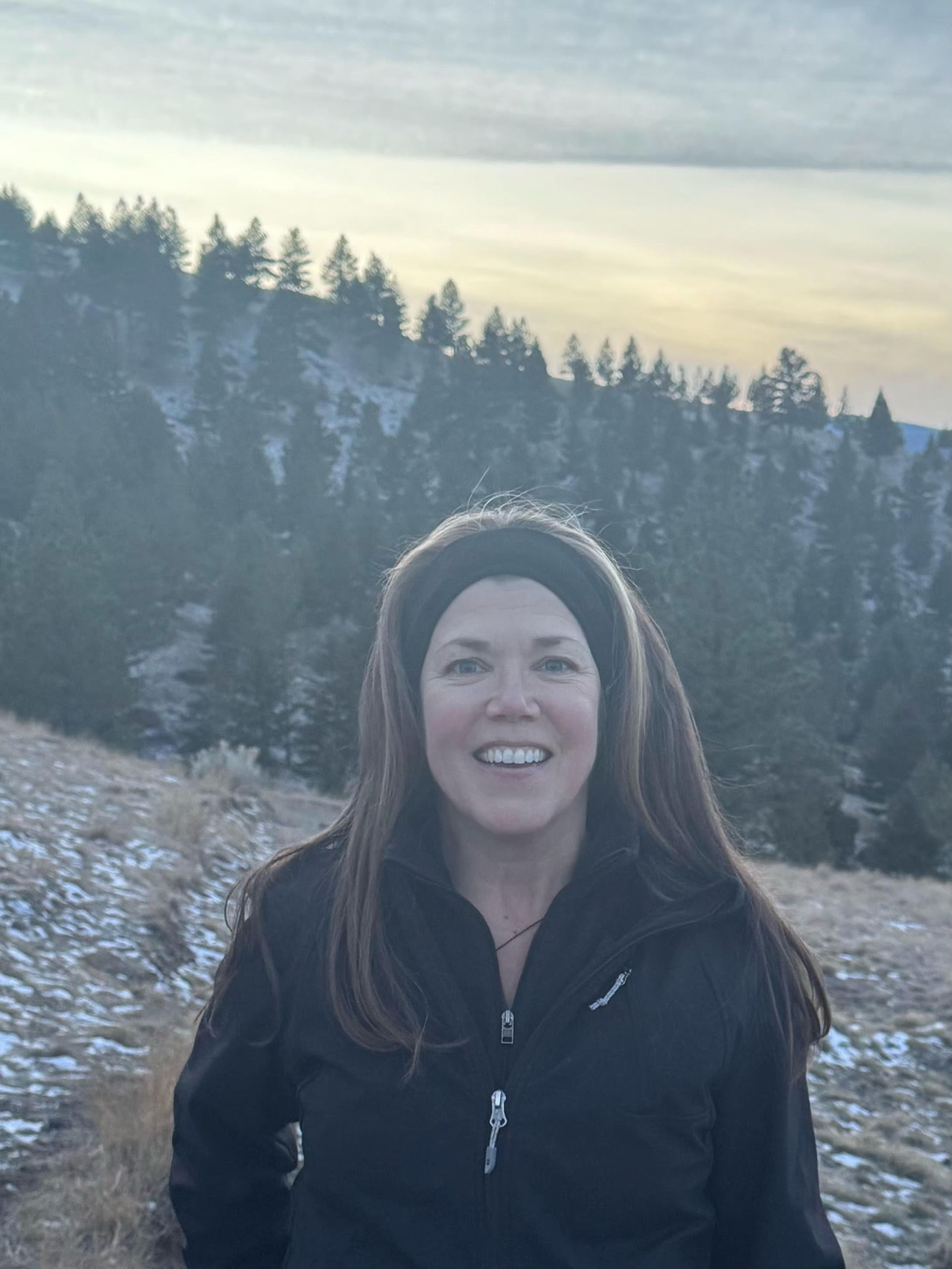 A man wearing a blue vest with a name tag on it