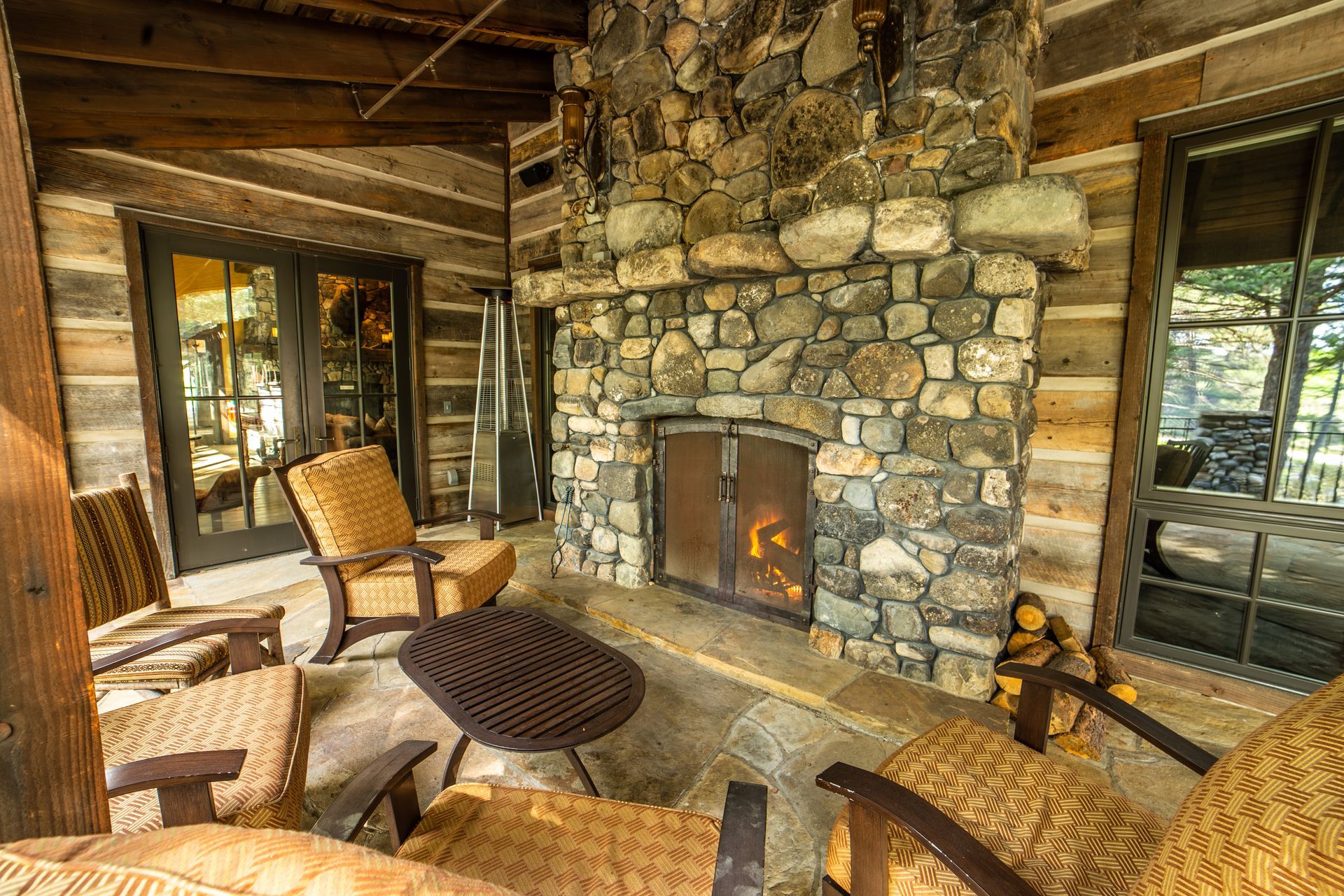 There is a stone fireplace in the middle of the room.
