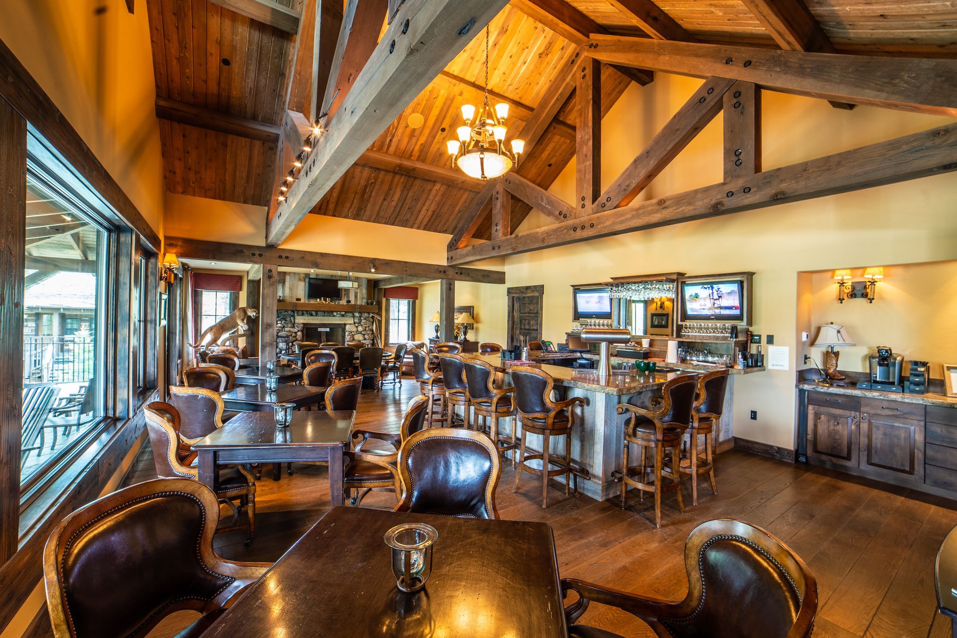 A restaurant with tables and chairs and a bar.