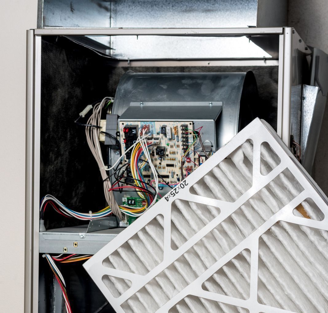 The inside of an air conditioner with a filter being removed.