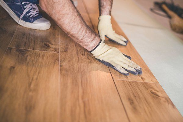 Worker Laying Laminate Floor — Thatcher, AZ — Woodside Construction, LLC