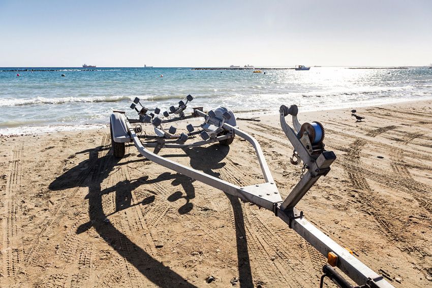 A Boat Trailer on the Beach Near the Ocean — Mackay Marine Services in Mackay, QLD