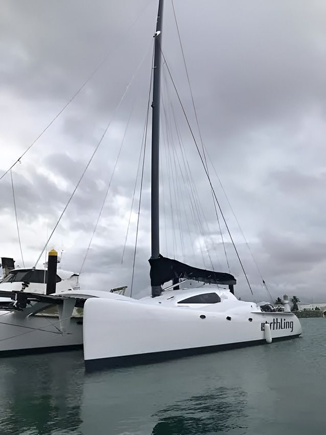 A White Sailboat is Docked in the Water — Mackay Marine Services in  Mackay, QLD