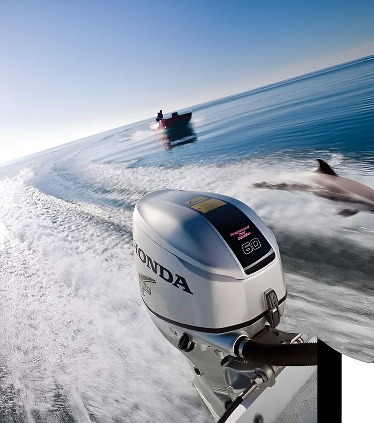 A Honda Outboard Motor is Driving a Boat in the Ocean — Mackay Marine Services in Mackay, QLD