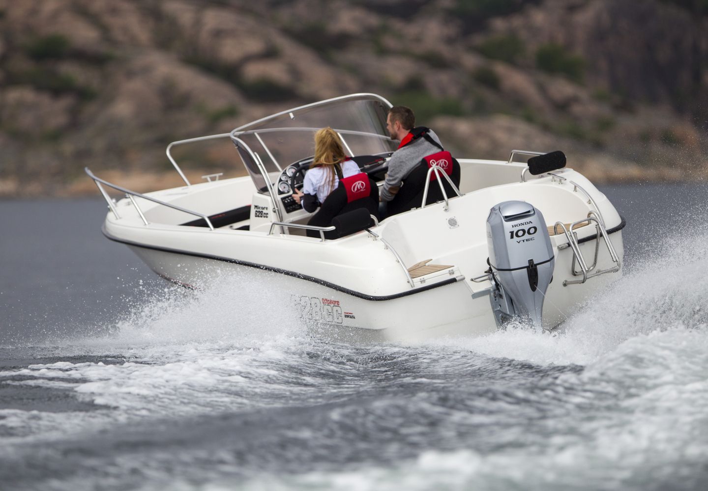 White Motorboat With Two People on Board, Moving Across Water — TJM Rockhampton in Rockhampton City, QLD