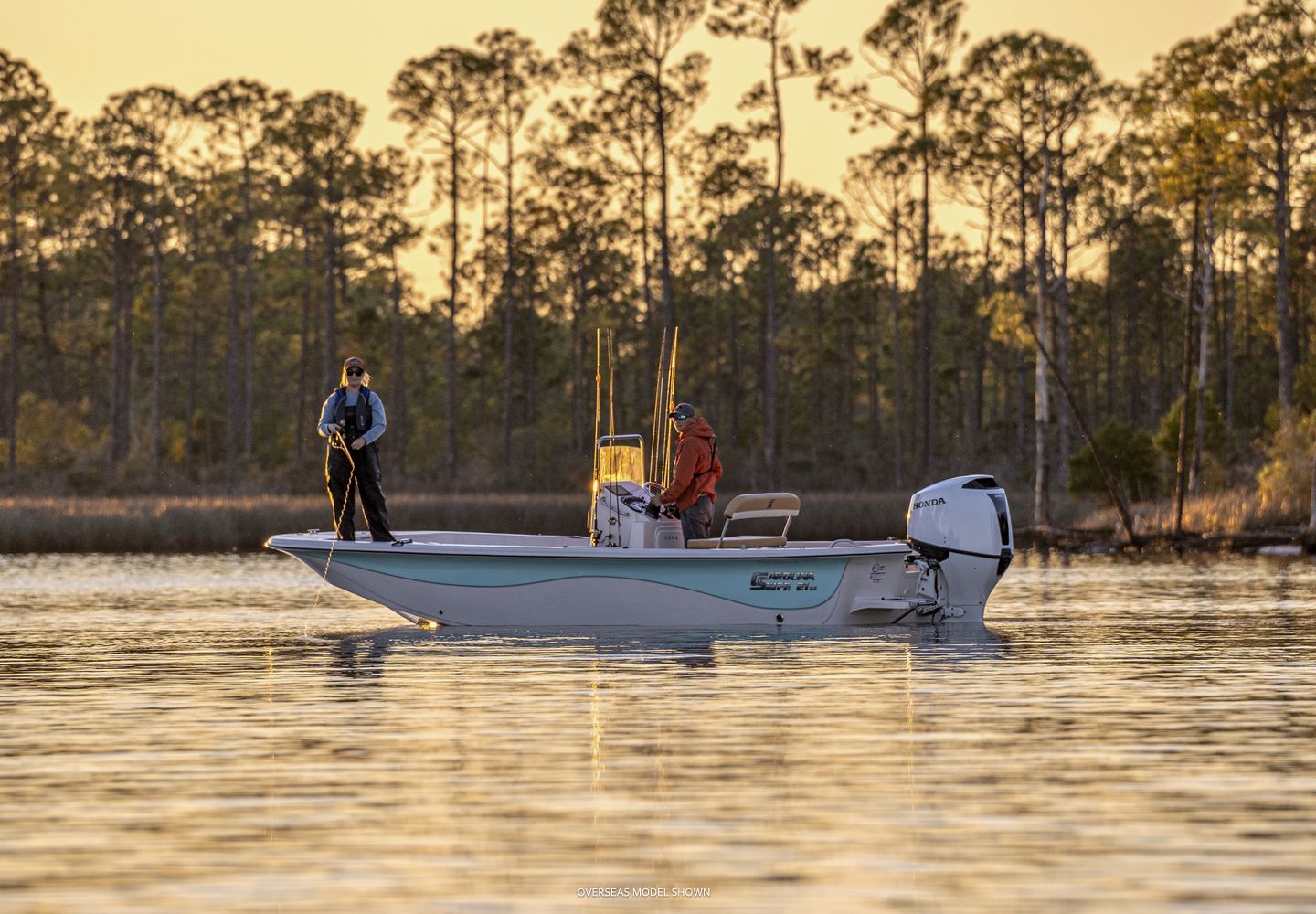 Two People Fishing From a Boat on Calm Water, Surrounded by Trees at Sunset — TJM Rockhampton in Rockhampton City, QLD
